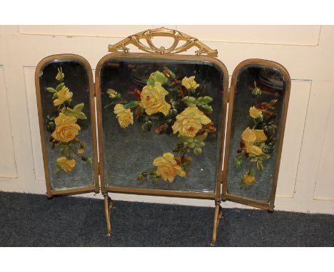 A Victorian triptych bevelled glass fire screen, painted with yellow roses, 96cm high
