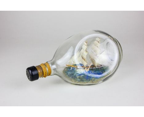 A two-masted model ship in a Haig & Haig whisky bottle, 23cm long