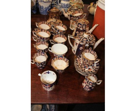 A Derby style part tea service comprising teapot, dish and cover, cream jug, cups and saucers in rust, blue and gilt (a/f)  (