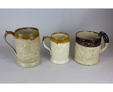 Three 19th century stoneware tankards embossed with scenes of hunting and revelry, one with a darker rim, the handle modelled