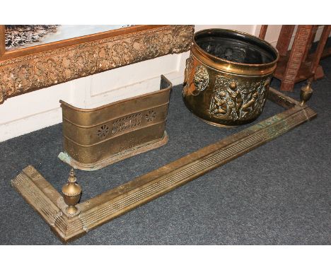A 20th century log bucket, cast with cupids in a forest, with two lion mark handles, 45cm together with a brass fire fender, 