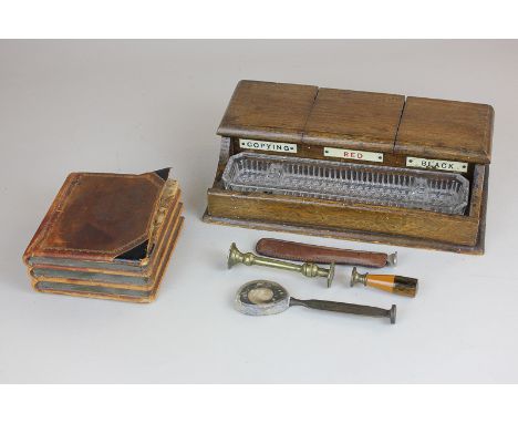 An oak desk stand with three inkwells, three various seals, a tamper and a trinket box