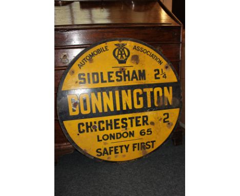 An Automobile Association circular enamelled roadside sign for Donnington, marking Sidlesham 2 1/2, Chichester 2, London 65 m