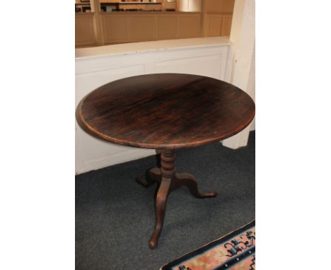 A 19th century circular oak tilt-top tripod table, 81cm diameter