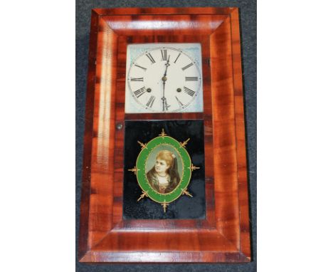 An American Waterbury wall clock with square enamel face with blue painted spandrels and Roman numerals, the movement strikin