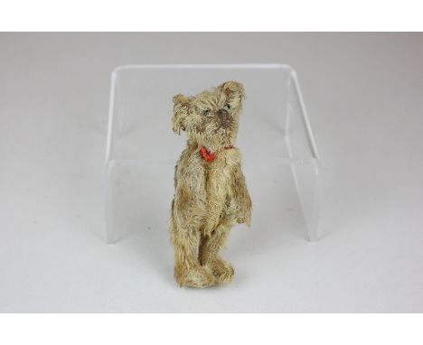 An early 20th century miniature jointed teddy bear with glass bead eyes, 10cm