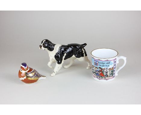 A Royal Crown Derby chaffinch paperweight with gold stopper, a Royal Doulton porcelain figure of a springer spaniel and a Roy