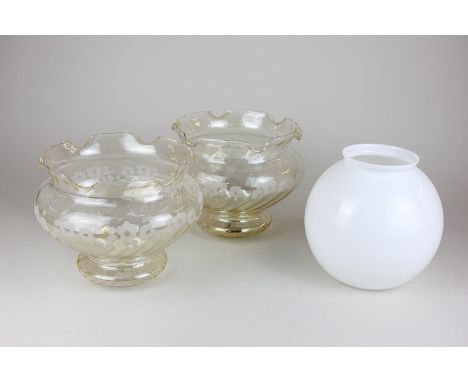 A pair of tinted glass lamp shades with floral decoration, together with a white glass oil lamp shade 