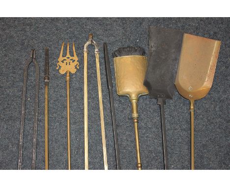 Eight various brass and cast iron fireside tools including shovels, tongs, pokers, a toasting fork and a brush