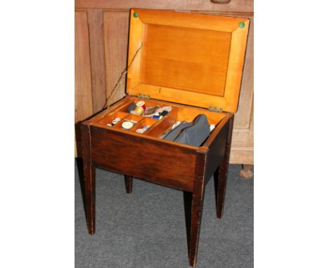 An early 20th century sewing box containing a large collection of buttons and other sewing related items and tools