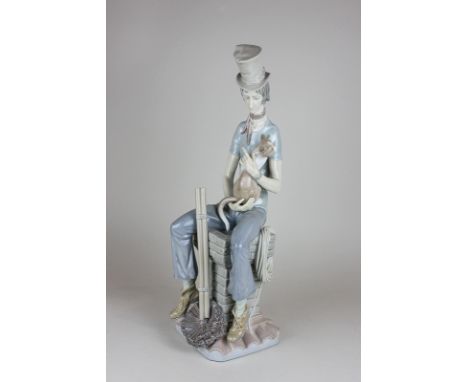 A Lladro porcelain figure of a seated chimney sweep with cat, 44cm high