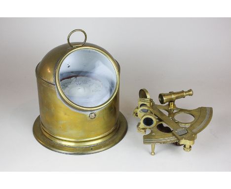 A brass sextant and a large ship's compass in brass surround