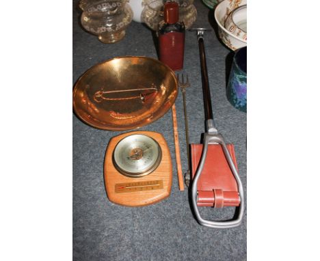 An aneroid barometer with thermometer mounted on wooden surround, a leather cased whiskey bottle, a shooting stick, a brass t