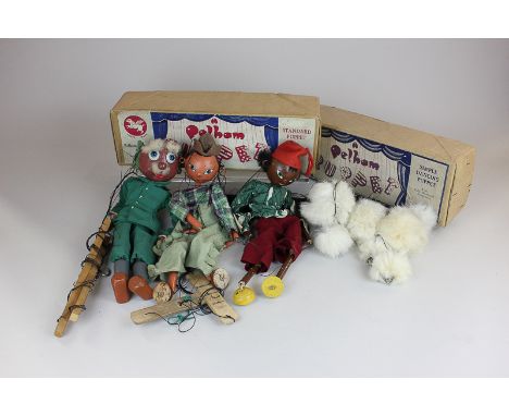 A simple dancing Pelham puppet and a standard Pelham puppet (both boxed), together with three other puppets, a Scotsman, a pi