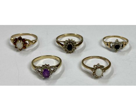 FIVE 9CT GOLD DRESS RINGS, opal and white pastes, size K, sapphire and pastes, size M, sapphire and CZ, size L, amethyst and 