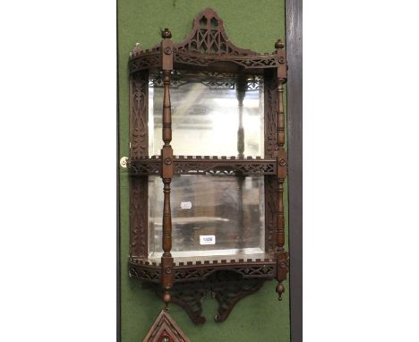 A Mahogany Chippendale Style Shelf Mirror, with pierced and carved fretwork galleries on turned supports, the bevelled mirror