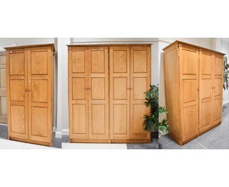 A Set of Three Matching 20th Century Oak Wardrobes; double, 99cm by 64cm by 194cm, treble, 143cm by 64cm by 194cm, and a four