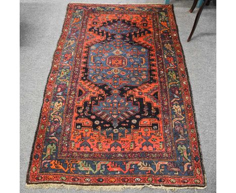 Kurdish Rug, the midnight blue field with indigo central panel framed by spandrels and borders of angular polychrome vines, 1