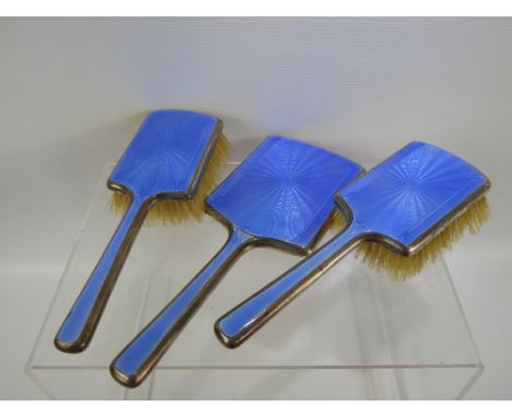 A Silver and Blue Enamel Dressing Table Set, comprising mirror and two hairbrushes, mm Mappin & Webb.