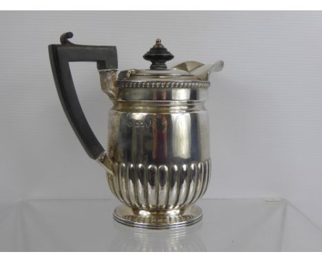 A Carrington & Co Silver Hot Water Pot, London hallmark, mm John Bodman, ribbed body with ebony handle and finial, approx 480