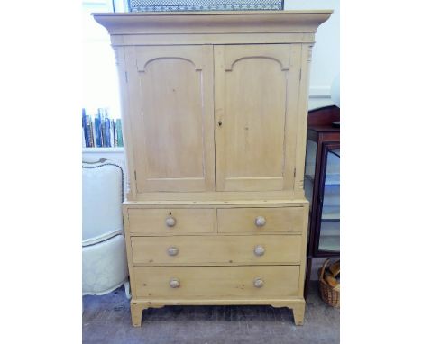 An Antique Pine Linen Chest, the top converted to cupboard space, two short and two long drawers raised on bracket feet, appr