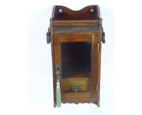 A Gentleman's Oak Smokers Cabinet, glazed fronted with single internal drawer and pipe rack, brass galleried decoration to fr