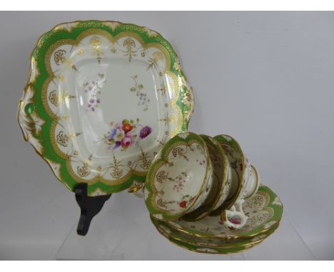 A Part English Porcelain Tea Set, green with hand-painted floral spray, comprising thirteen saucers, six tea cups, four coffe