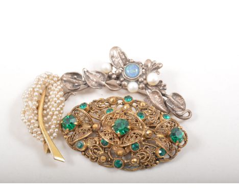 Silver charm bracelet, a silver brooch set with pearls and an opal and three other brooches.