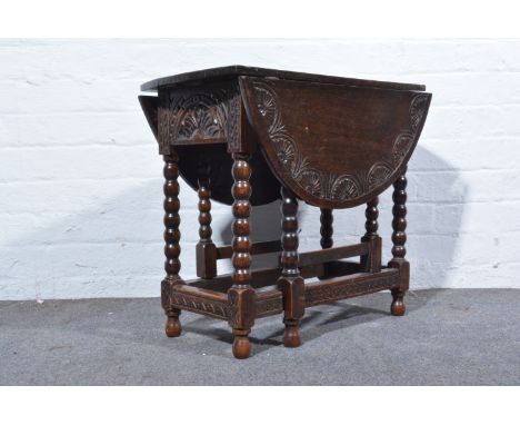 Small 19th Century oak two fall leaf table, with carved decoration, frieze drawers and bobbin turned supports, width 62cm.