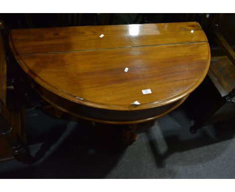 Victorian mahogany demi lune console table, with a hinged compartment, plain frieze, scrolled front leg, on a platform, width