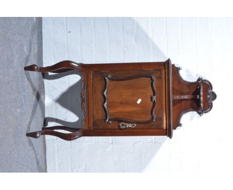 Victorian mahogany pedestal cupboard, with shaped back and raised shelf, moulded outline to the single door, cabriole supppor