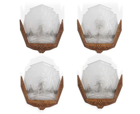 Jean GauthierFour Art Deco wall sconces moulded with stylised flowers and geometric fan-shaped shades, circa 1930Gilt metal m