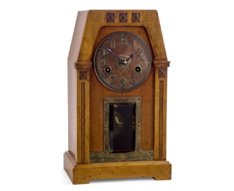 Glasgow SchoolArts and Crafts twin-train mantel clock carved with Glasgow roses, circa 1900Oak, copper dial, bevelled glass p