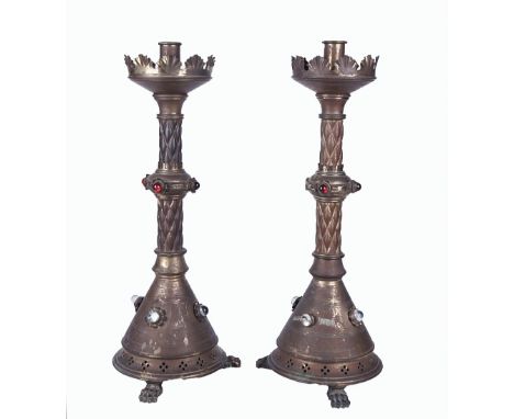 A PAIR OF VICTORIAN GILT BRASS AND CABOCHON GLASS MOUNTED GOTHIC REVIVAL ALTAR CANDLESTICKS (2)19th Century, with clear and r