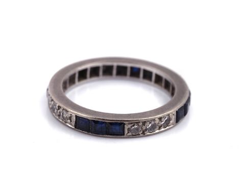 A SAPPHIRE AND DIAMOND ETERNITY RINGMounted with rows of three circular cut diamonds, alternating with rows of three square c