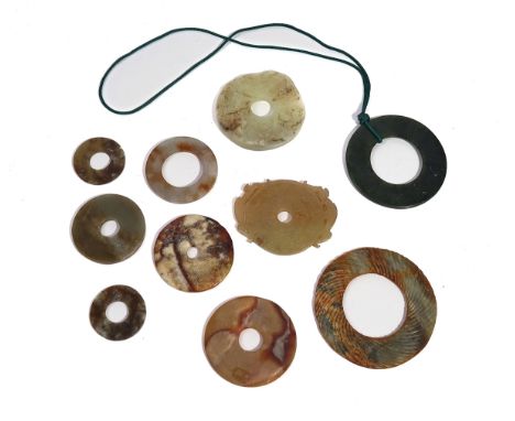 A GROUP OF CHINESE ARCHAISTIC JADE DISCSOf various forms and colour, 4cm to 9cm diameter (10)Overall in good condition