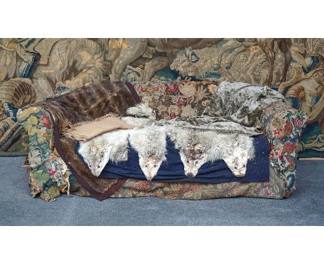 WNAI - HOWARDS LTD 25.26&amp;27 BERNERS ST. LONDONA large Chesterfield style sofa with arched back and outswept arms on oak t