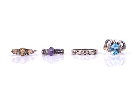 AN 18CT GOLD, BLUE TOPAZ AND DIAMOND RING AND THREE FURTHER RINGS (4)The 18ct gold ring mounted with a pear shaped blue topaz