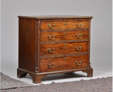 A SMALL MID-18TH CENTURY MAHOGANY CHESTWith brushing slide over four long graduated drawers, flanked by canted fluted corners