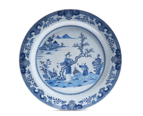 A LARGE CHINESE BLUE AND WHITE CHARGERLate 18th centuryPainted with a woman holding a fish accompanied by a child in a river 