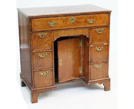 A GEORGE II WALNUT KNEEHOLE DESKWith seven drawers about the kneehole cupboard, 78cm wide; 47cm deep; 80cm highCondition repo