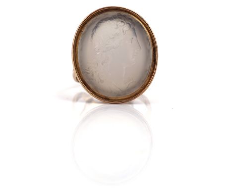 A WHITE AGATE AND GOLD SEAL CONVERTED FOR WEAR AS A RINGThe oval intaglio carved as a classical portrait, the mount in an ope