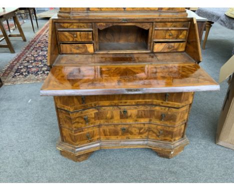 AN 18TH CENTURY NORTH ITALIAN INLAID FIGURED WALNUT BUREAU BOOKCASEThe mirrored cupboard top section over fitted interior and