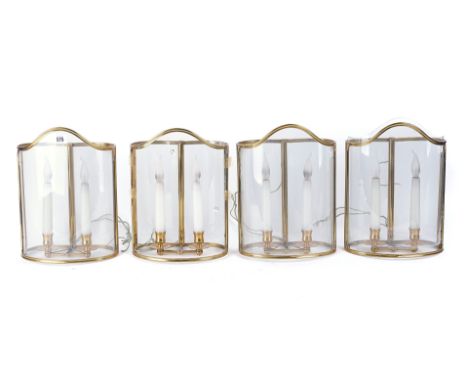 A SET OF FOUR BRASS AND GLASS STORM LANTERNS20th CenturyEach with a twin light fitment, wired for electricity, 33cm highCondi