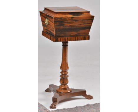 A REGENCY COROMANDEL AND ROSEWOOD TEAPOYOf sarcophagus form, with chequer banding to the top and lion mask ring handles, the 
