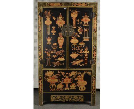 A CHINESE 20TH CENTURY GILT-DECORATED BLACK LACQUERED CABINETEnclosing two drawers and two shelves, 104.5cm wide; 51cm deep; 