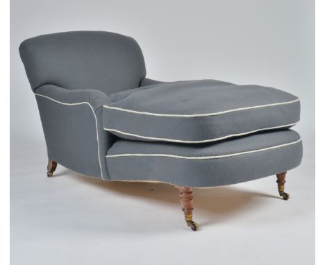 A GREY UPHOLSTERED CHAISE LONGUE WITH ARMSOn turned mahogany supports, the castors stamped 'HOWARD AND SONS', 150cm long; 85c