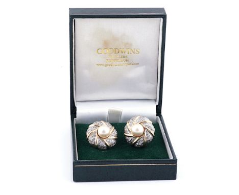 A PAIR OF GOLD, DIAMOND AND CULTURED PEARL EARCLIPSThe central cultured pearls in a wave scroll surround of pave set circular