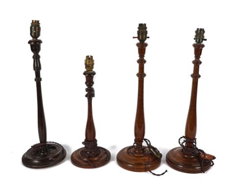 FOUR MAHOGANY CANDLESTICK TABLE LAMPS (4)With slender baluster uprights and urn-shaped nozzles, the pair, 45cm high excluding