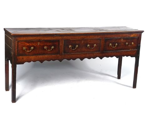 AN 18TH CENTURY OAK DRESSER BASEWith three frieze drawers, on canted block supports, 190cm wide; 85cm highCondition report:&n